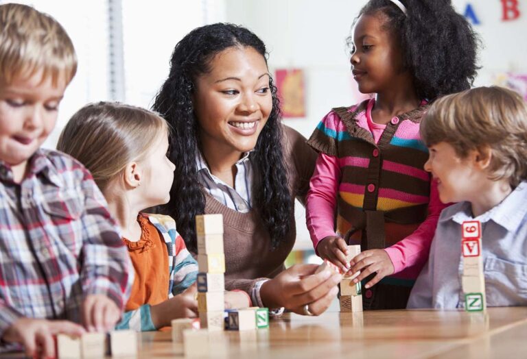 Pre-K Kids playing with letter blocks